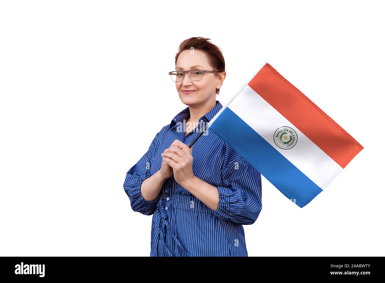 Paraguay flag. Woman holding Paraguay flag. Nice portrait of middle aged lady 40 50 years old holding a large flag isolated on white background. Stock Photo