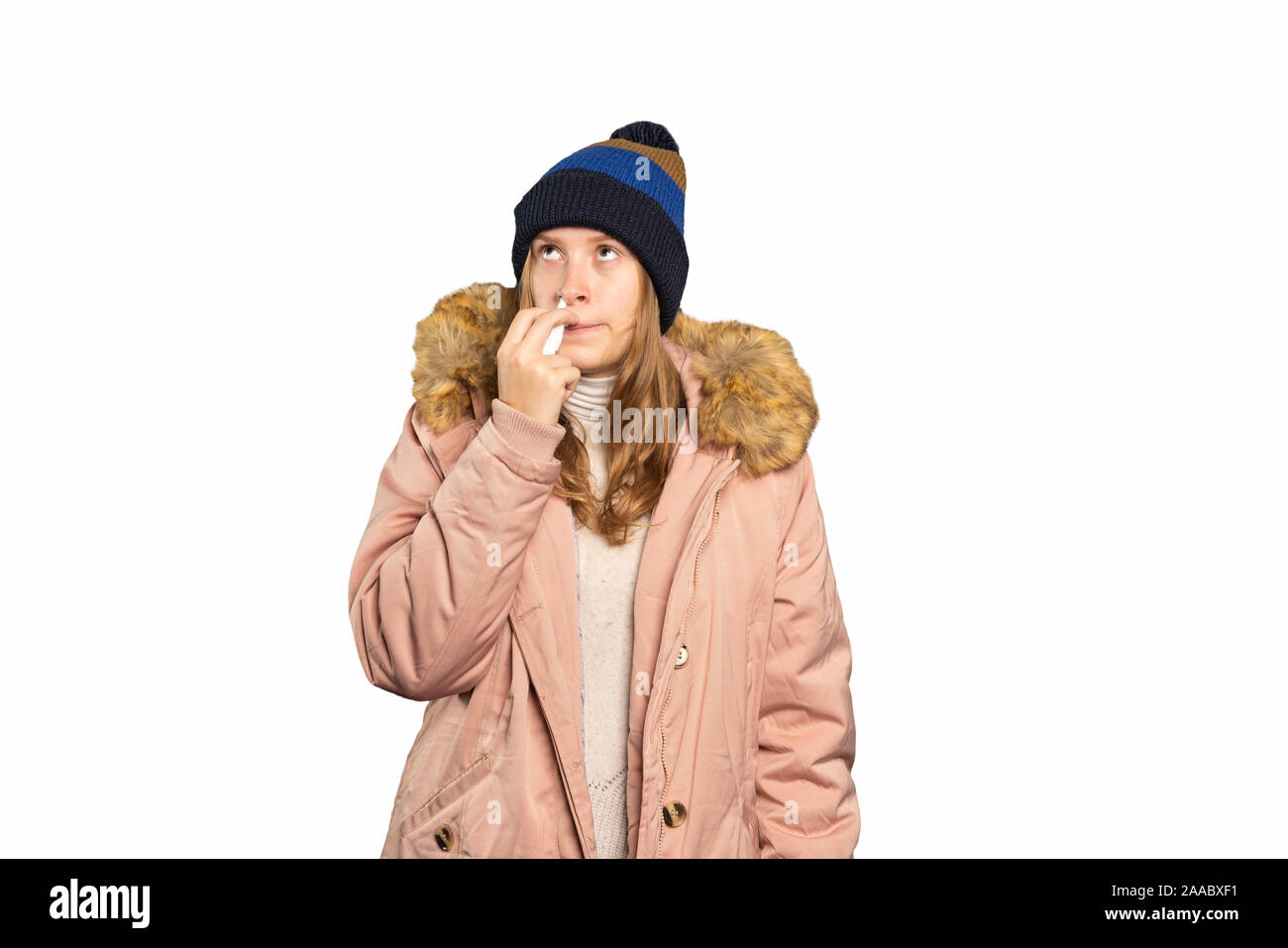 A young woman is ill and takes a nasal spray Stock Photo