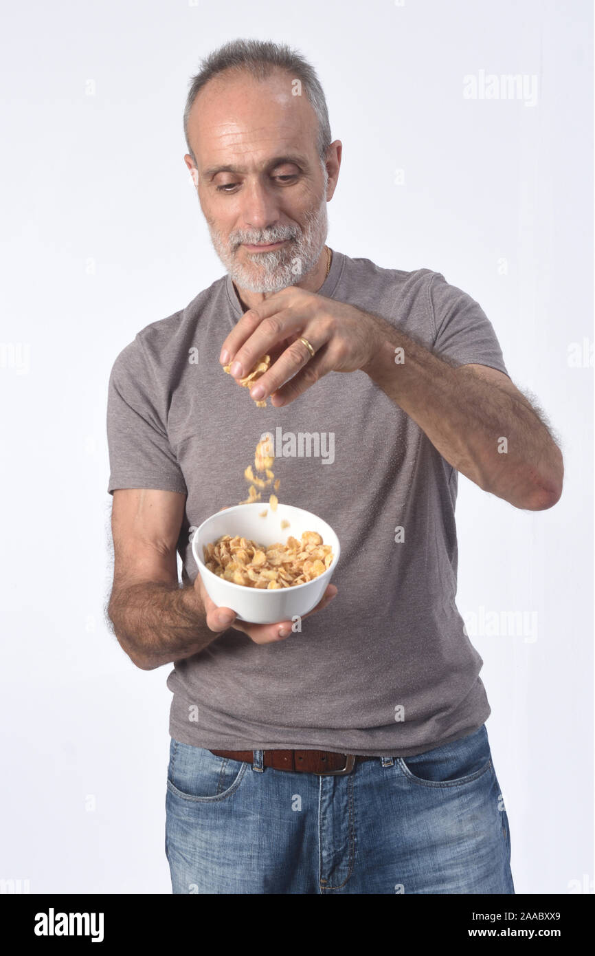 man with corn flakes bar on white background Stock Photo Alamy