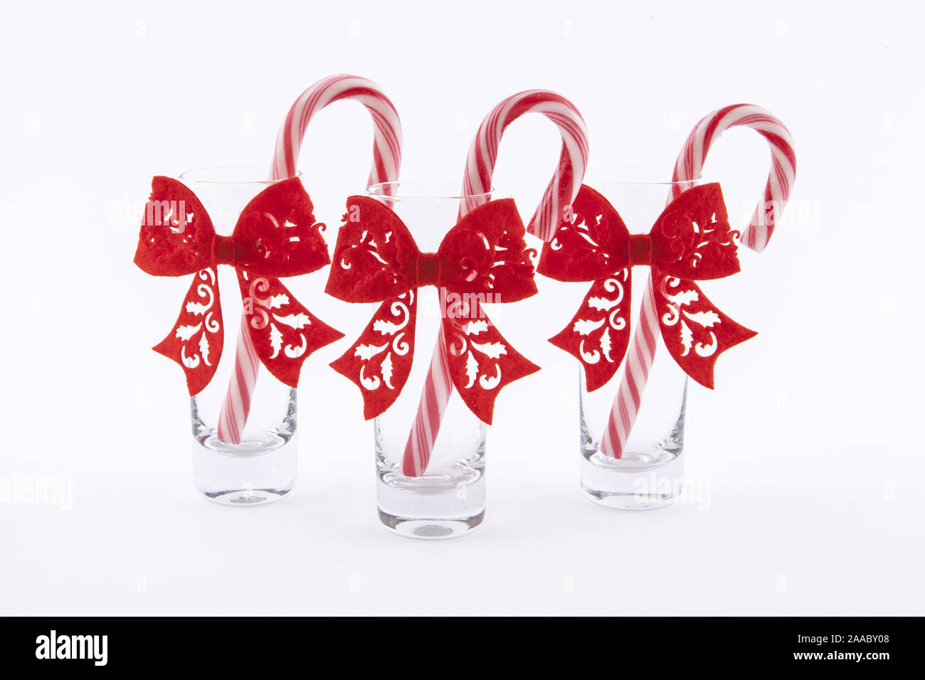three traditional christmas candies cane in the glass on a white background Stock Photo Alamy