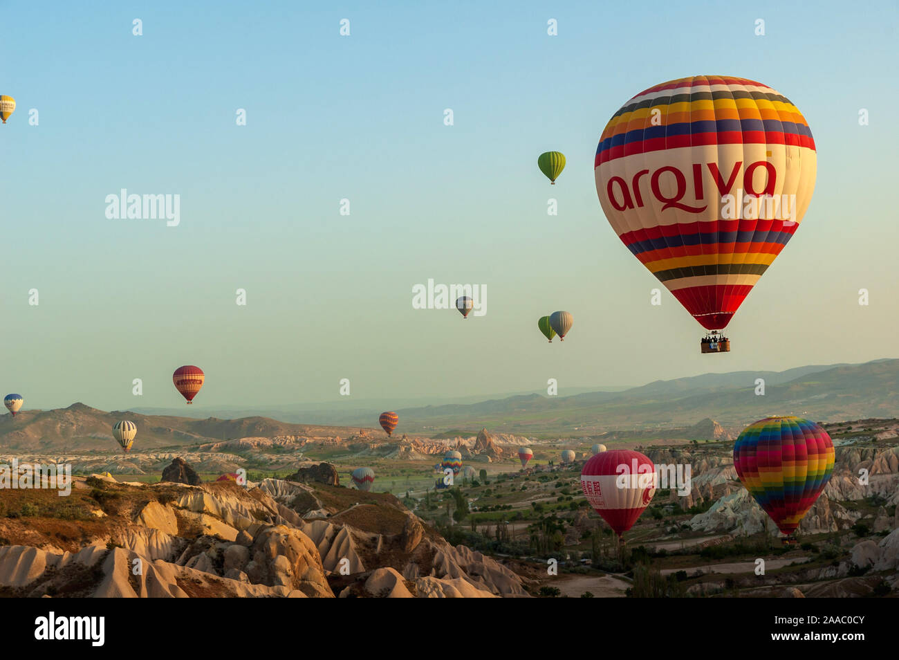 Hot air balloon flying over rock landscape at Cappadocia Turkey at the ...
