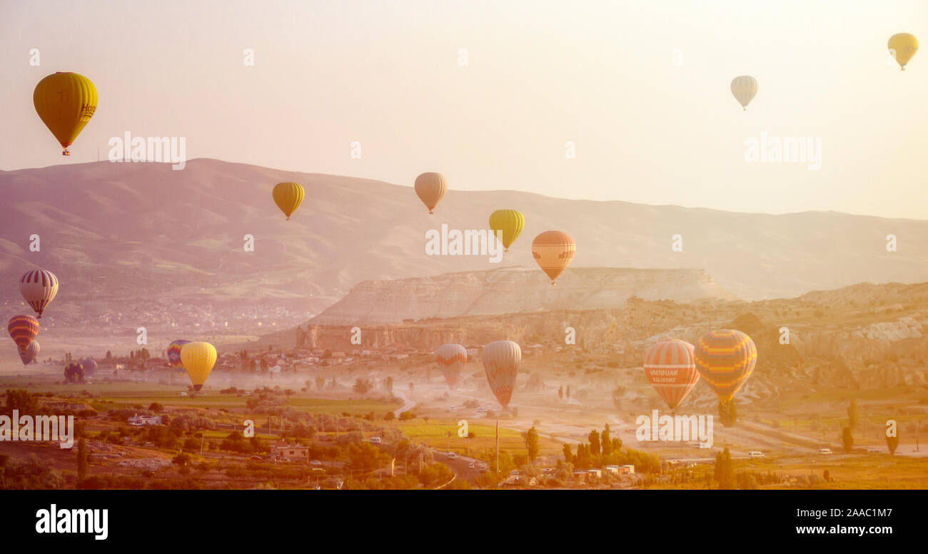 Hot air balloon flying over rock landscape at Cappadocia Turkey at the ...