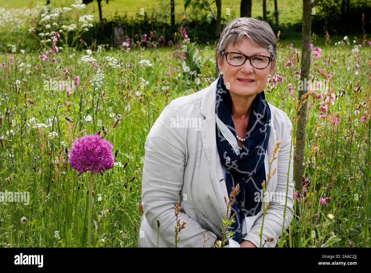 Lady Delia Thornton in the wildflower meadow area of her garden Stock