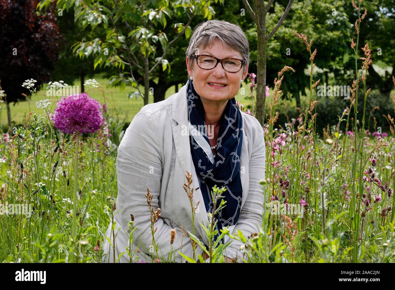 Lady Delia Thornton in the wildflower meadow area of her garden Stock