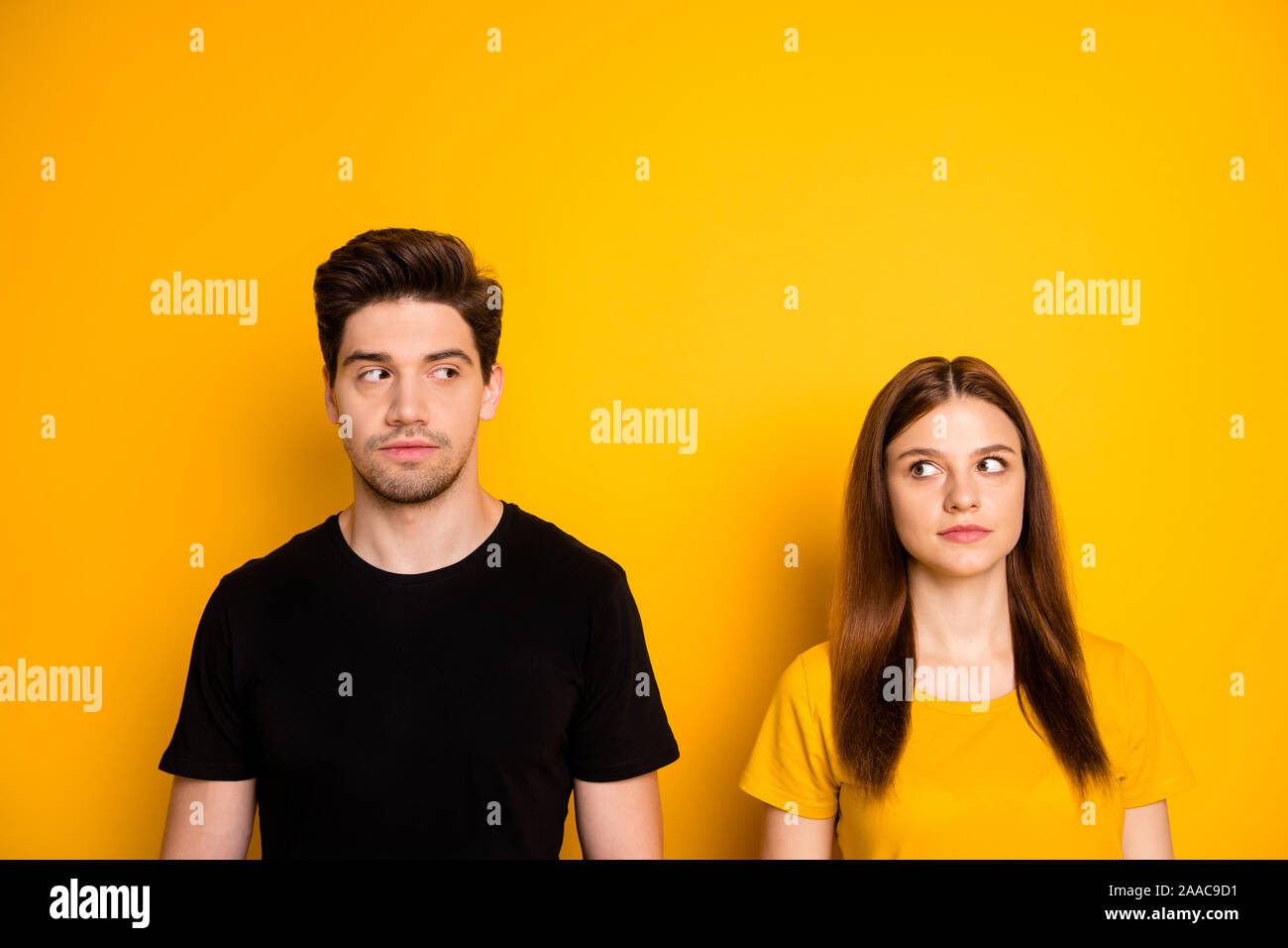 Photo of suspicious thinking pondering couple uncertain about each other looking suspiciously suspecting isolated over vibrant shiny color background Stock Photo