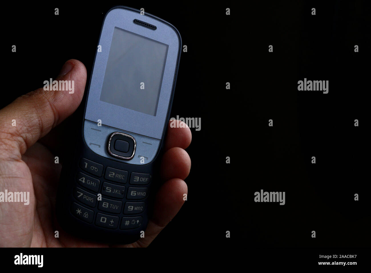 Photo of old and used mobile phone with keypad. Stock Photo