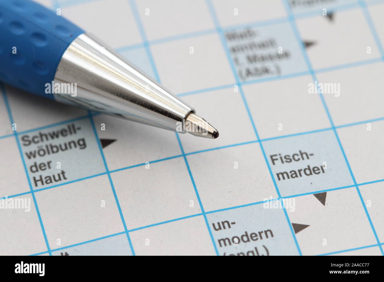 A Crossword Puzzle With A Pen Stock Photo Alamy