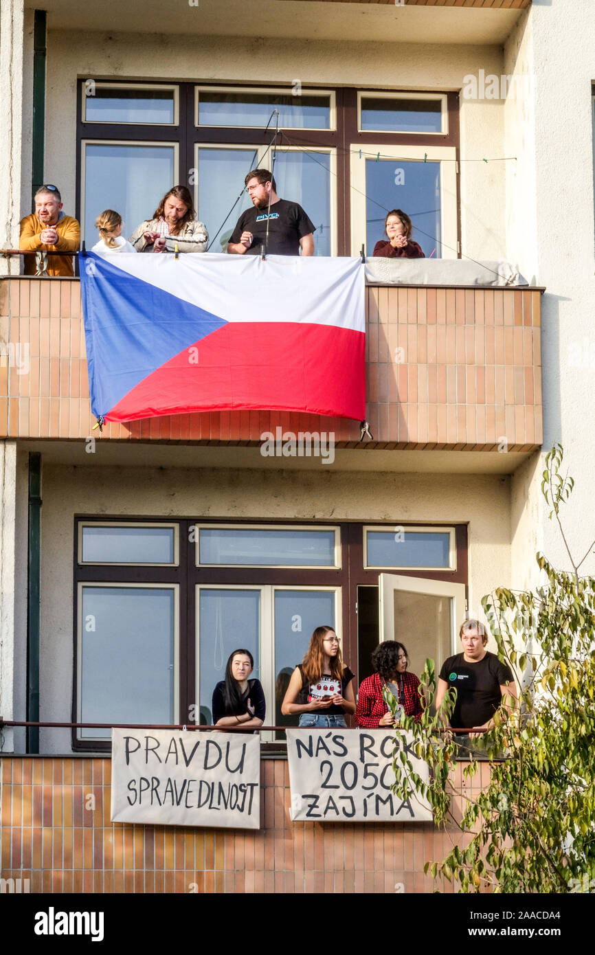 People on balcony with Czech flag and banners watching demonstration against Babis, Letna Prague Czech Republic Stock Photo