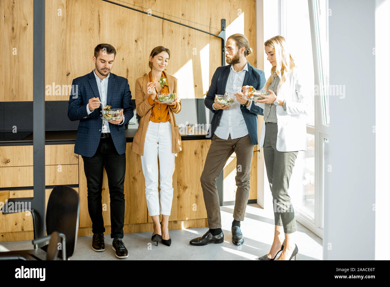 Group Of A Young Office Workers Eating Salads And Drinking Coffee At The Modern Office Canteen Concept Of A Healthy Takeaway Food On The Work Stock Photo Alamy