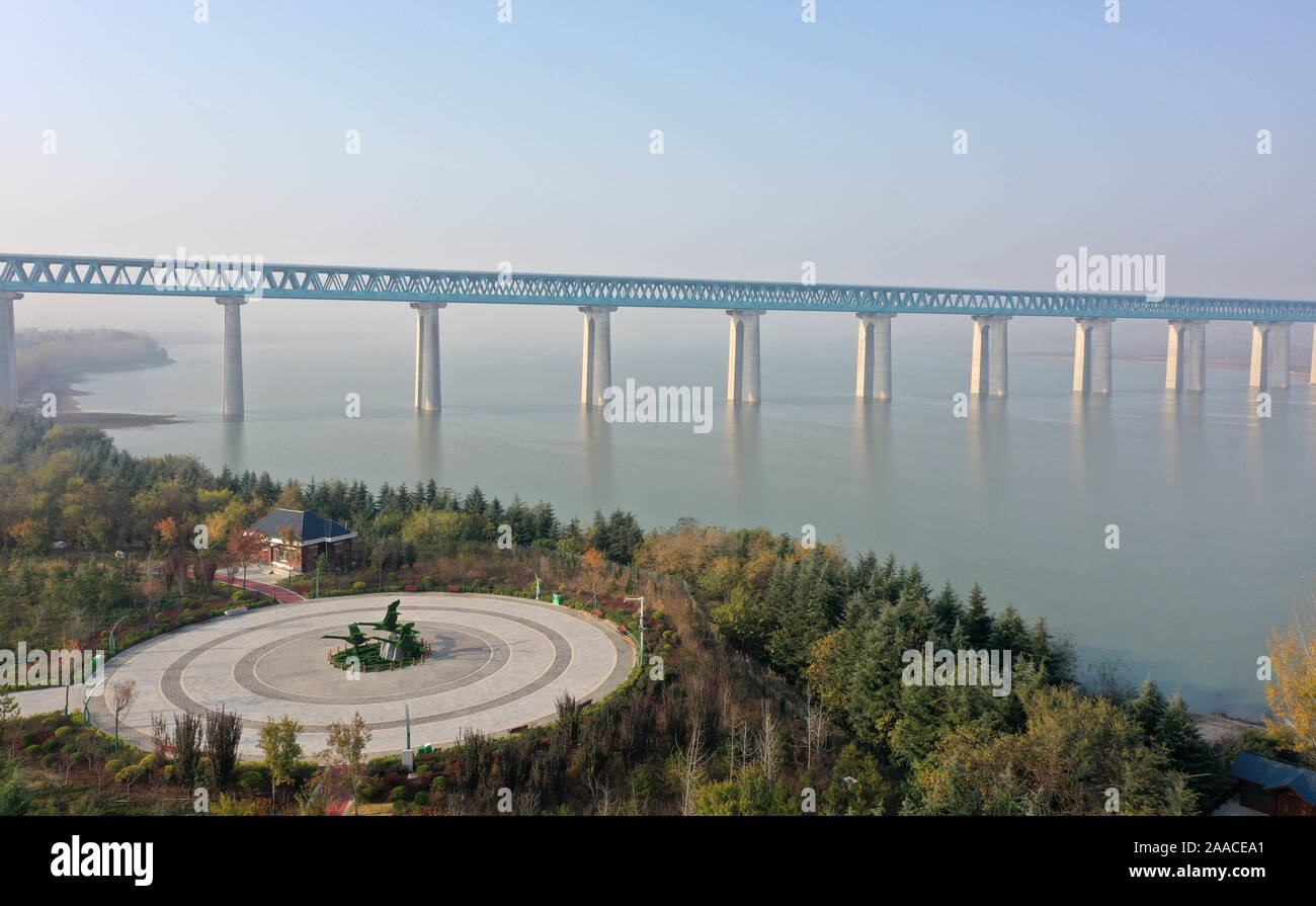 November 21, 2019, Henan, Henan, China: HenanÃ¯Â¼Å’CHINA-Haoji railway Sanmenxia Yellow River road and railway bridge in Sanmenxia city, henan province, Nov. 21, 2019.The main bridge is located in the Sanmenxia reservoir area of the Yellow River. The south bank of the bridge is Sanmenxia city of Henan province, and the north bank is connected to Yuncheng city of Shanxi Province.The bridge is 5600 meters long, 42 meters wide, 75 meters high and has 428 underwater pile foundations...Sanmenxia Yellow River bridge has created three world first.First, the upper structural steel truss girder of the Stock Photo