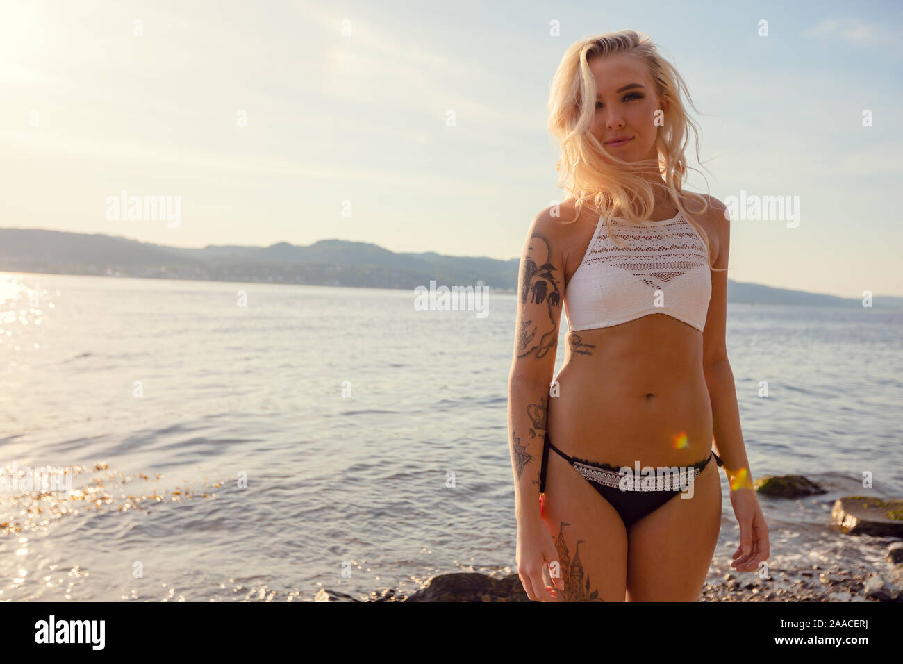 Portrait Of Beautiful Young Woman In Bikini At Beach Stock Photo