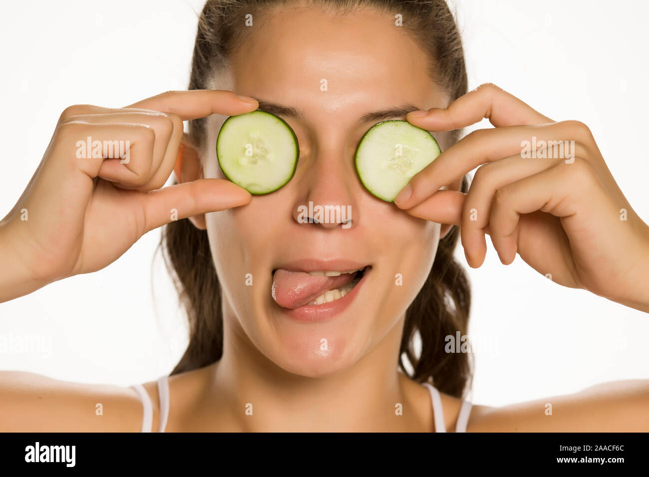 Young woman with cucumber slices on the face in a spa saloon Stock