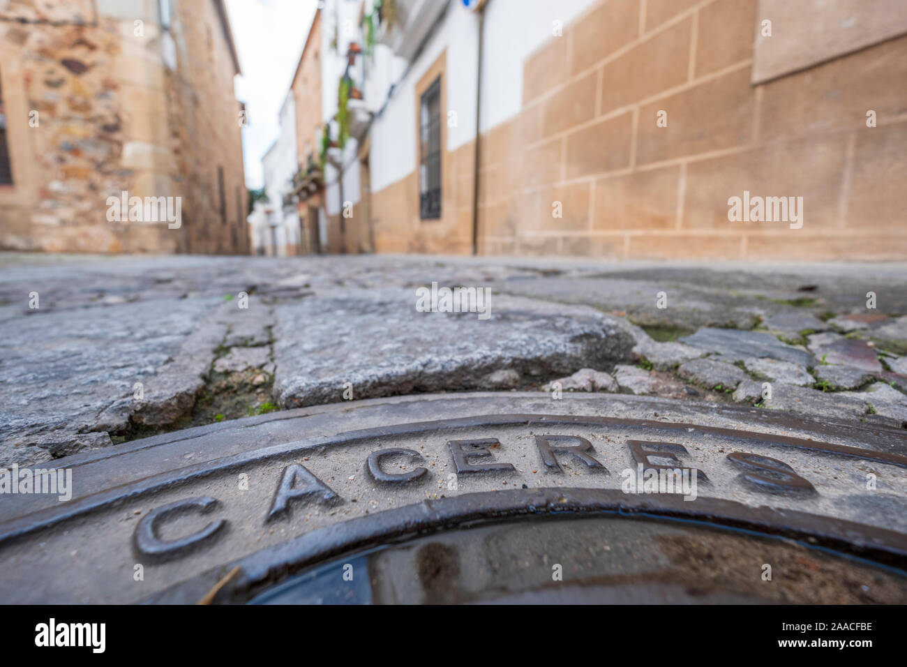 manhole cover in the streets with inscription caceres in the old eponymous historic capital of the province of caceres, extremadura, spain Stock Photo