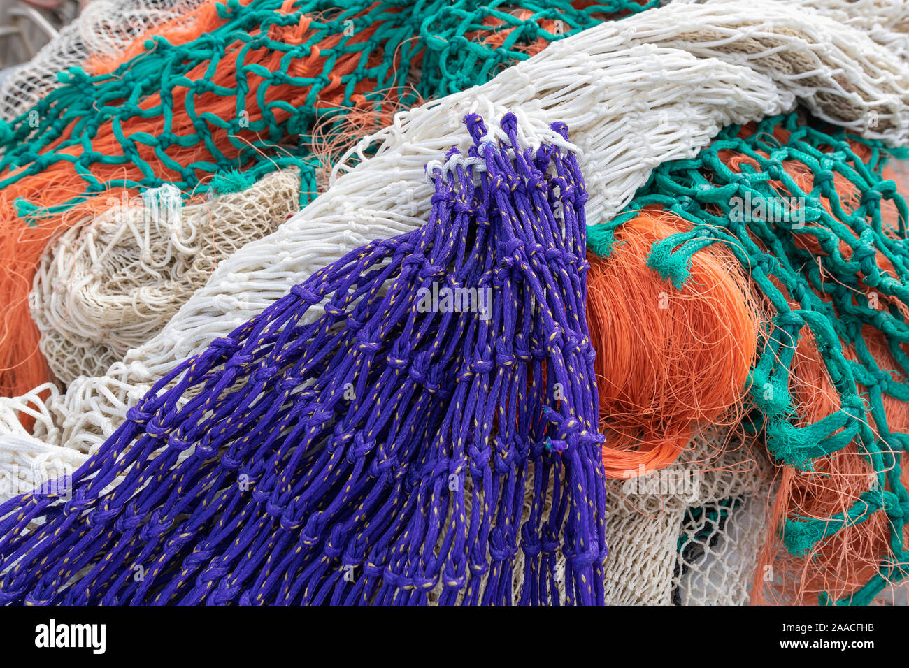 Multi colored fishing nets in a Dutch port in the North of the Netherlands Stock Photo
