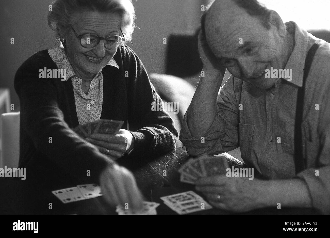 elderly couple playing cards Stock Photo