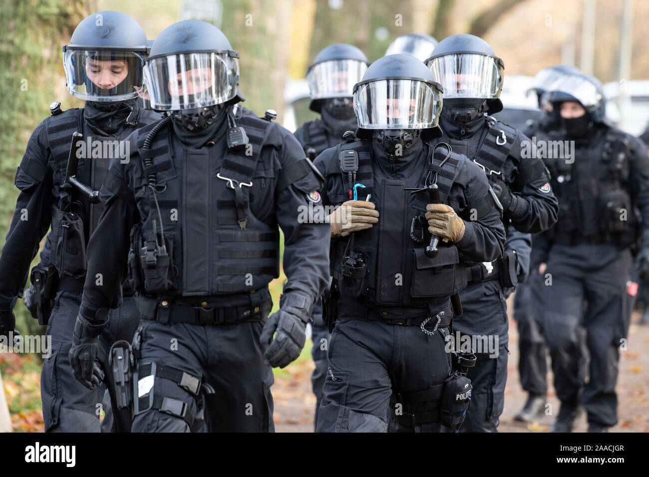 Leverkusen, Germany. 21st Nov, 2019. Policemen with helmets walk outside the stadium. Again and again police officers have to do with aggressive football fans, at Bundesliga matches there are often hundreds of people on the spot. The emergency forces in Leverkusen have rehearsed what to pay particular attention to during such missions. Credit: Federico Gambarini/dpa/Alamy Live News Stock Photo