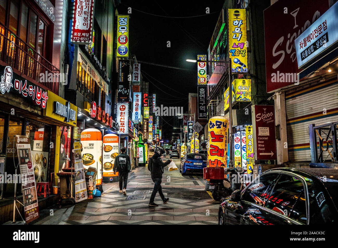 Incheon Korea , 7 October 2019 : Restaurants and bars street view with colourful shop signs and people at night in Incheon South Korea Stock Photo