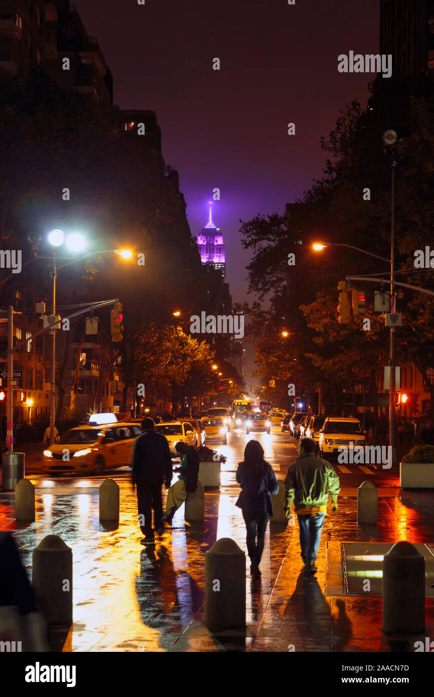 New York, New York State, United States of America. Looking down 5th Avenue from Washington Square North on a rainy night. Empire State Building in ba Stock Photo