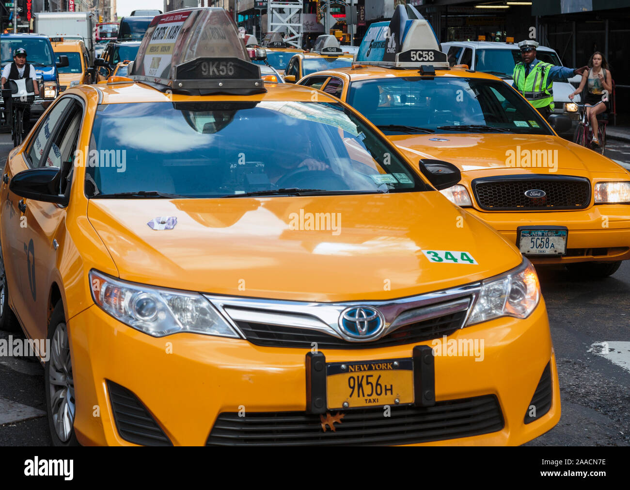 New York, New York State, United States of America.  City traffic.  Yellow cabs.  Policeman directing traffic. Stock Photo