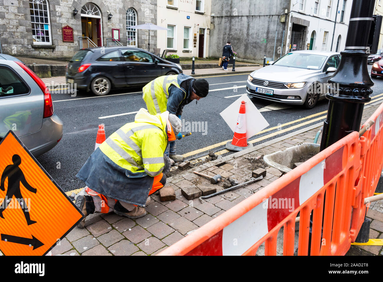 Men fixing pavement in Sligo Town, County Sligo, Ireland. Stock Photo