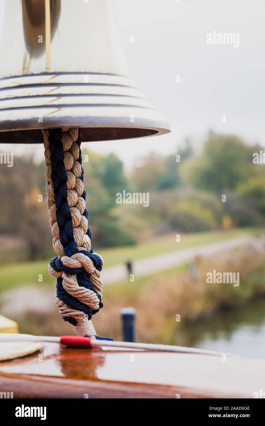 Ship bell close up. Metal brass bell with rope holder. Alert concept