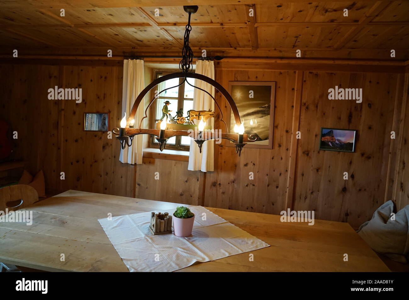 Warm welcoming cozy wooden tyrol hutte inside in the tyrol alm . Stock Photo