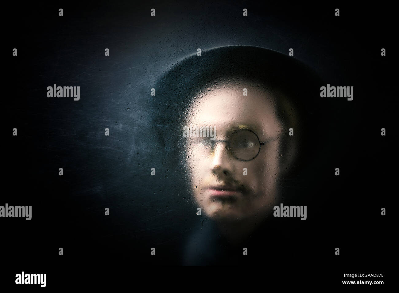 Mystery figure behind a dusty scratched glass Stock Photo