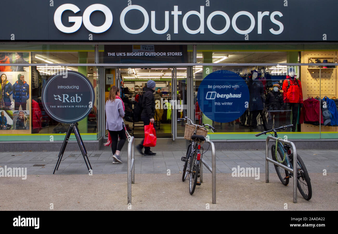 People strolling through a winter apparel store in Southport, Merseyside, UK, owned by GO Outdoors, a retail brand that specialises in camping goods, tents, outdoor clothing and footwear. Stock Photo
