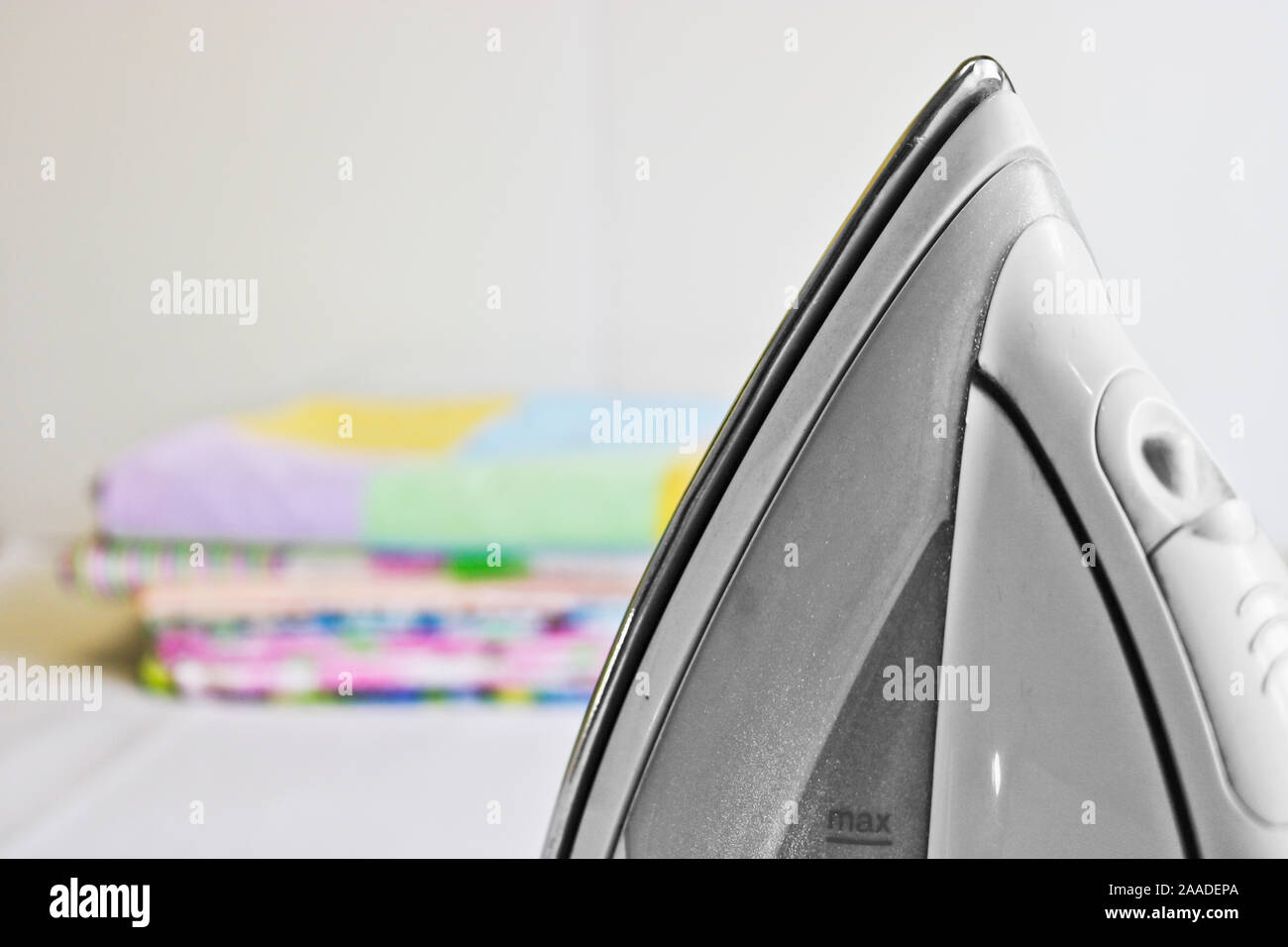 Modern iron and stack of ironed linen. Household chores Stock Photo Alamy