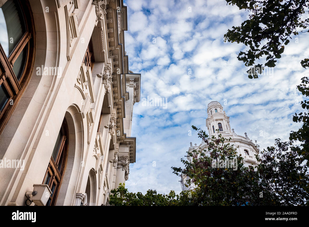 Facade of large institutional building with large columns and windows, background sky, low angle shot, in Valencia. Stock Photo