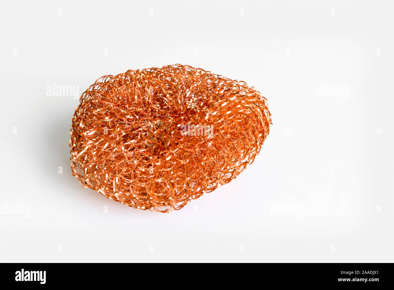 Kitchen metal washcloth for complex pollution on a light background. Stock Photo