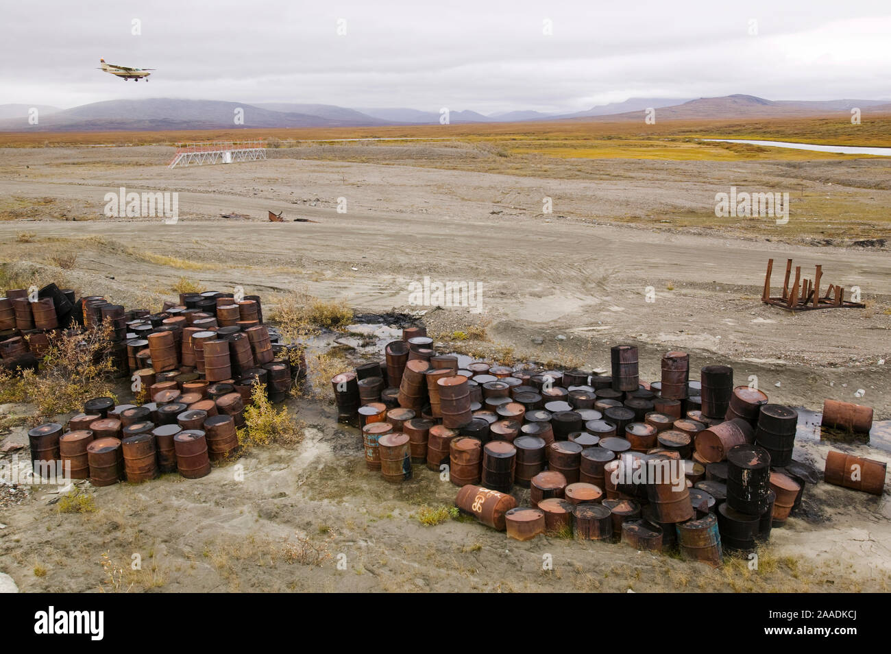 Abandoned barrels of leaking waste oil on the tundra, Nome, Alaska, USA, September 2004. Stock Photo