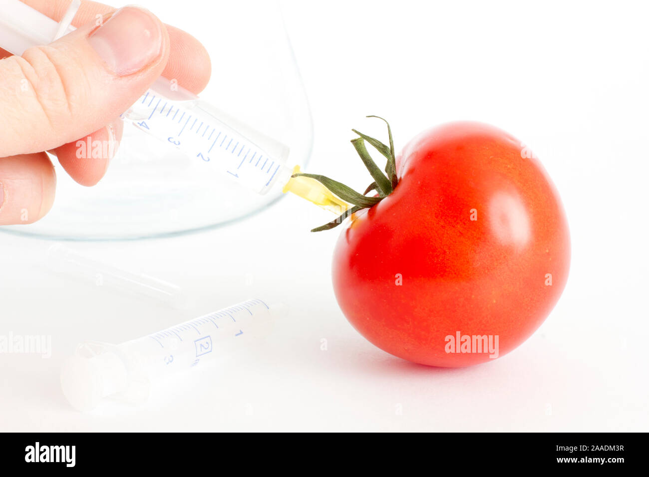 Spritze in Tomate Stock Photo