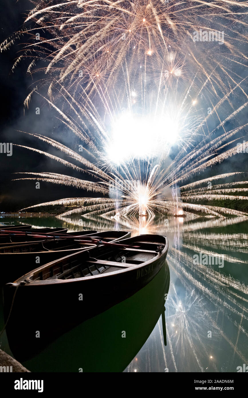 Rowboats and fireworks at Lake Lavarone. Trento province, Trentino Alto-Adige, Italy, Europe. Stock Photo