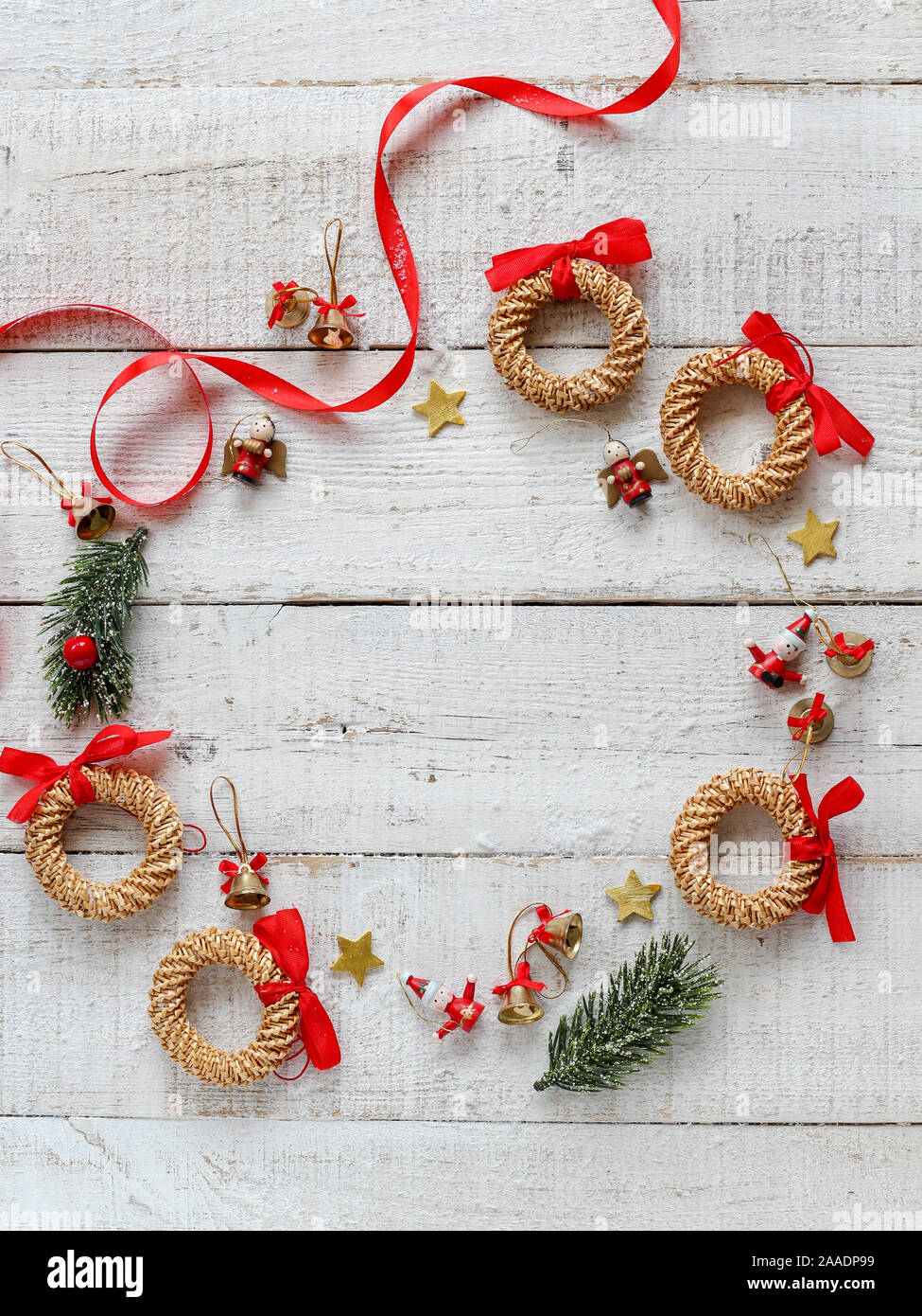Classical Christmas wreath with red details with a copy space in the middle on a white wooden background Stock Photo