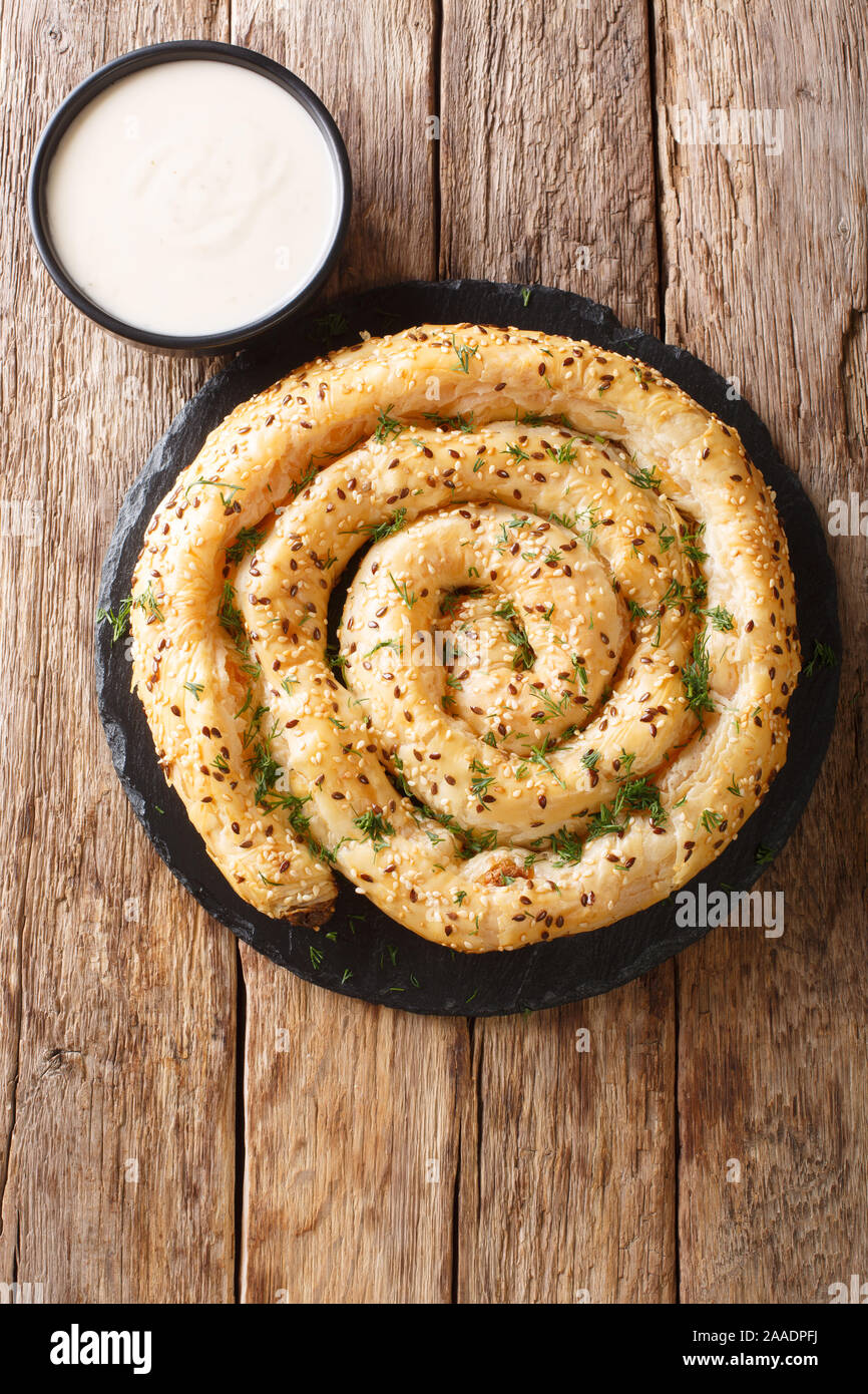 Tasty turkish borek pie (burek) with feta closeup on the table.Vertical top view from above Stock Photo