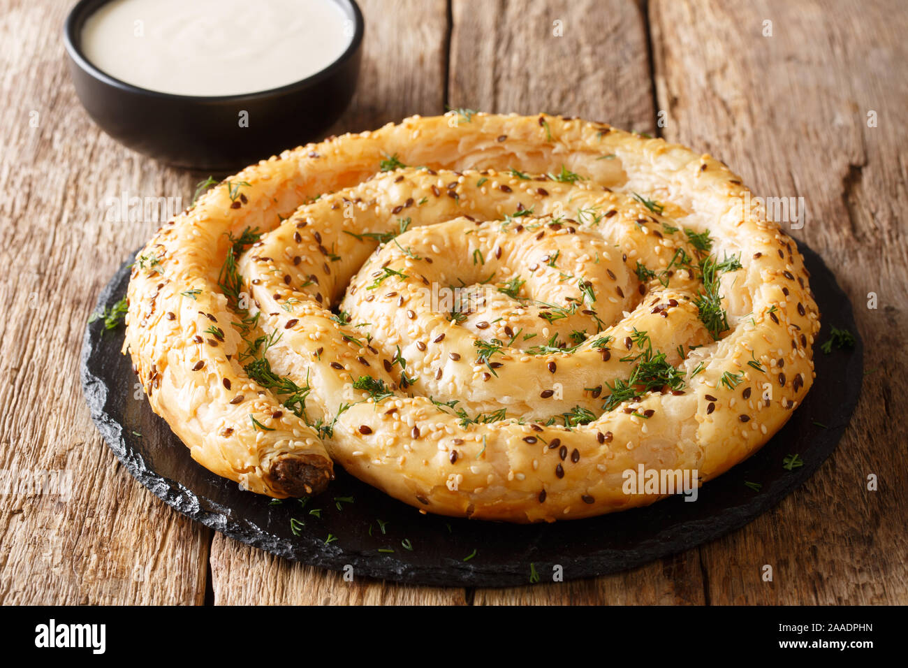 Snail pie borek (burek) from filo pastry with feta cheese closeup on the table. horizontal Stock Photo