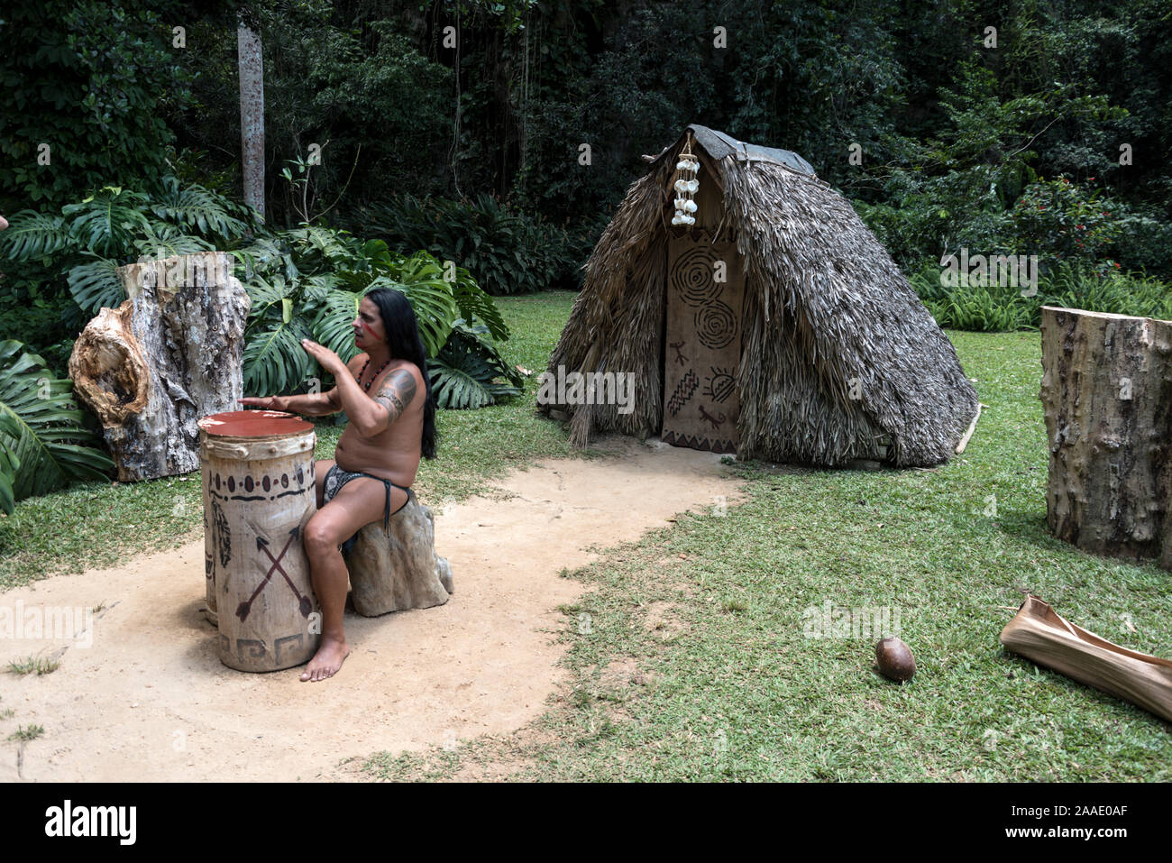 A member of the Taino-Arawak people, performing some traditional music to visiting tourists, visiting the Cueva del Indio, (Indian Cave), a cave, firs Stock Photo