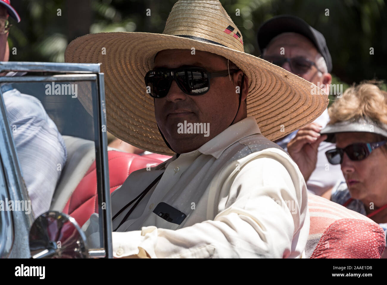 A driver wearing a Cuban traditional wide brim hat made from palm