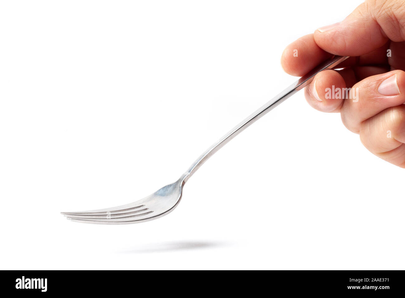 Metallic empty eating fork in a human right hand isolated on white ...