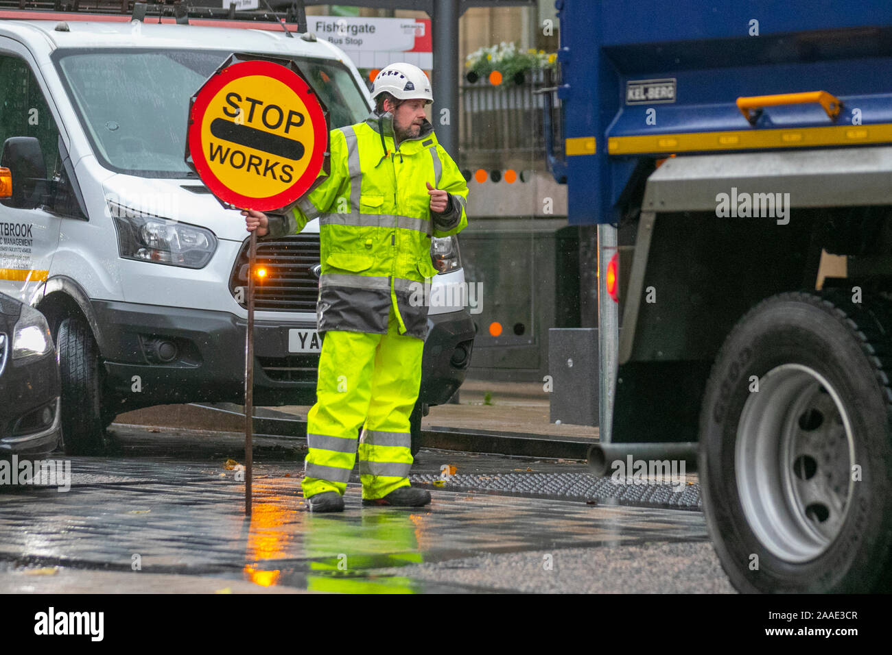 Lollipop Stop And Go Traffic Sign; Traffic Control Workman holding traffic with handheld Stop sign, UK Stock Photo