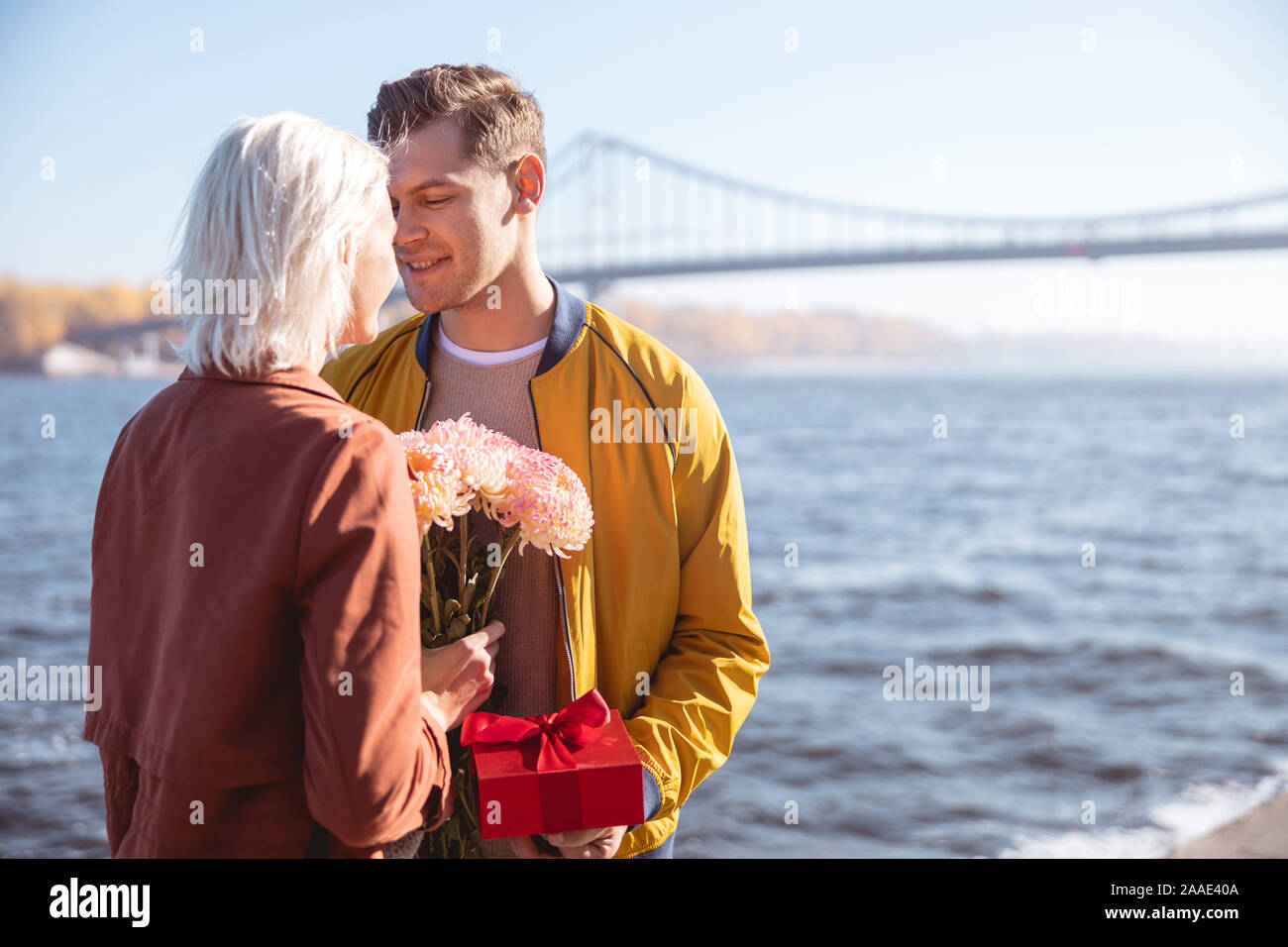 Man giving his girlfriend her birthday gift Stock Photo