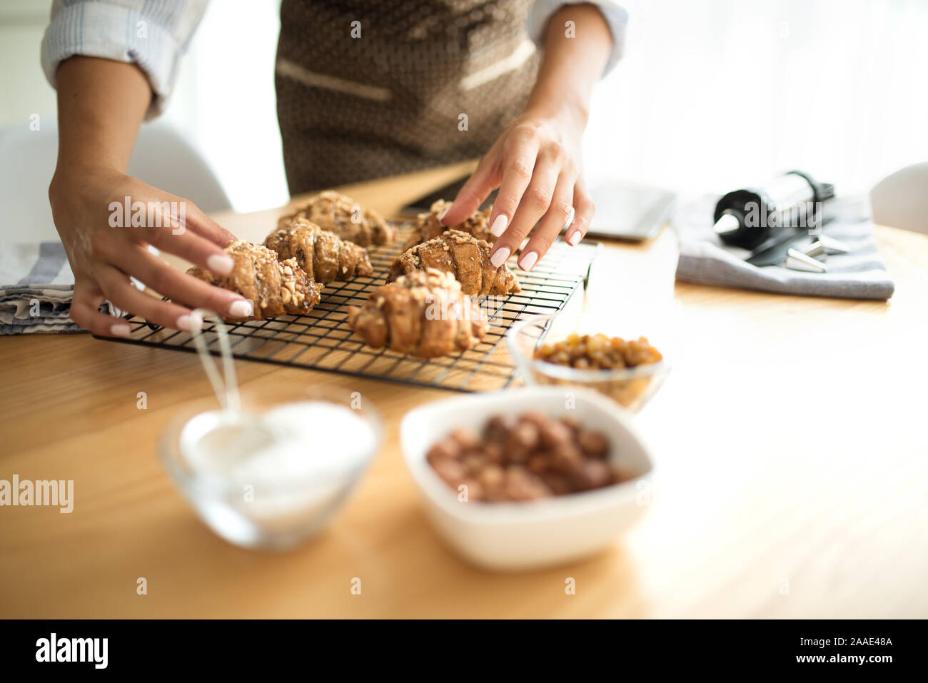 Young woman in the kitchen serves baked cookies Stock Photo