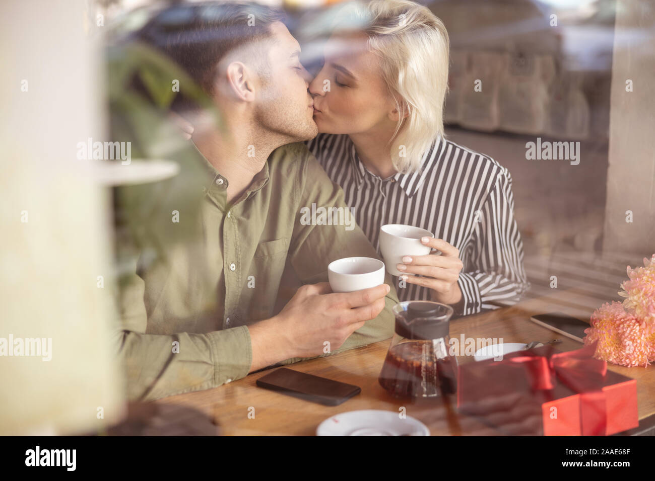Beautiful couple having their first kiss on the date Stock Photo - Alamy