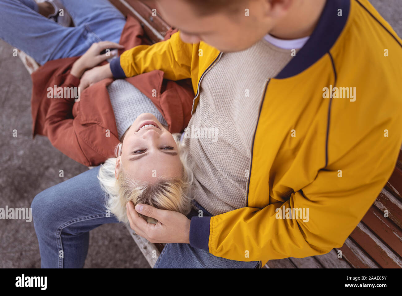 Handsome man stroking his pretty girlfriend outside Stock Photo Alamy