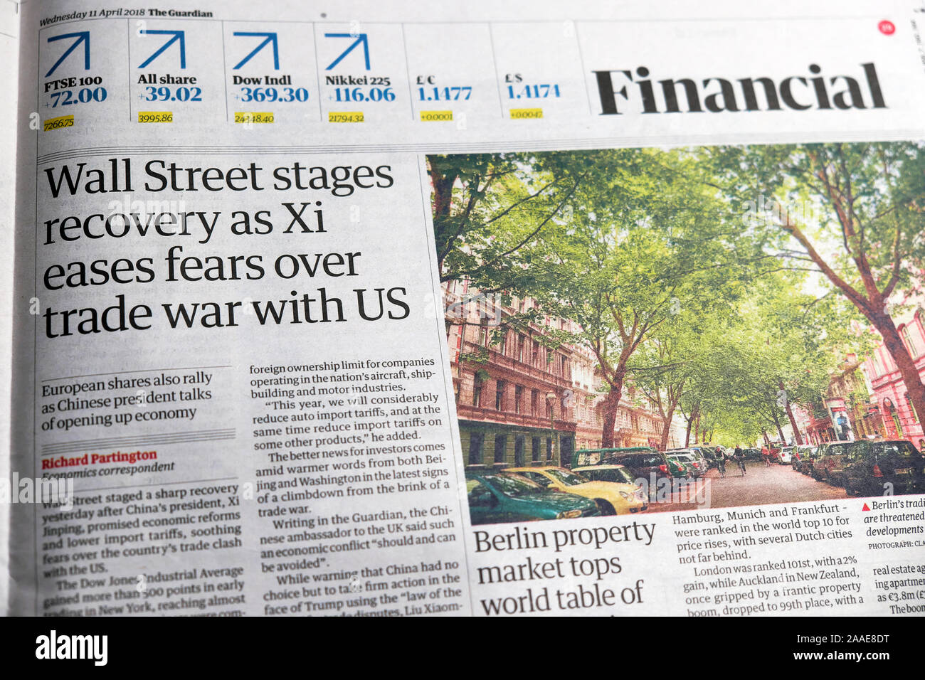 'Wall Street stages recovery as Xi eases fears over trade war with US' newspaper article in Guardian financial section 11 April 2018 London UK Stock Photo