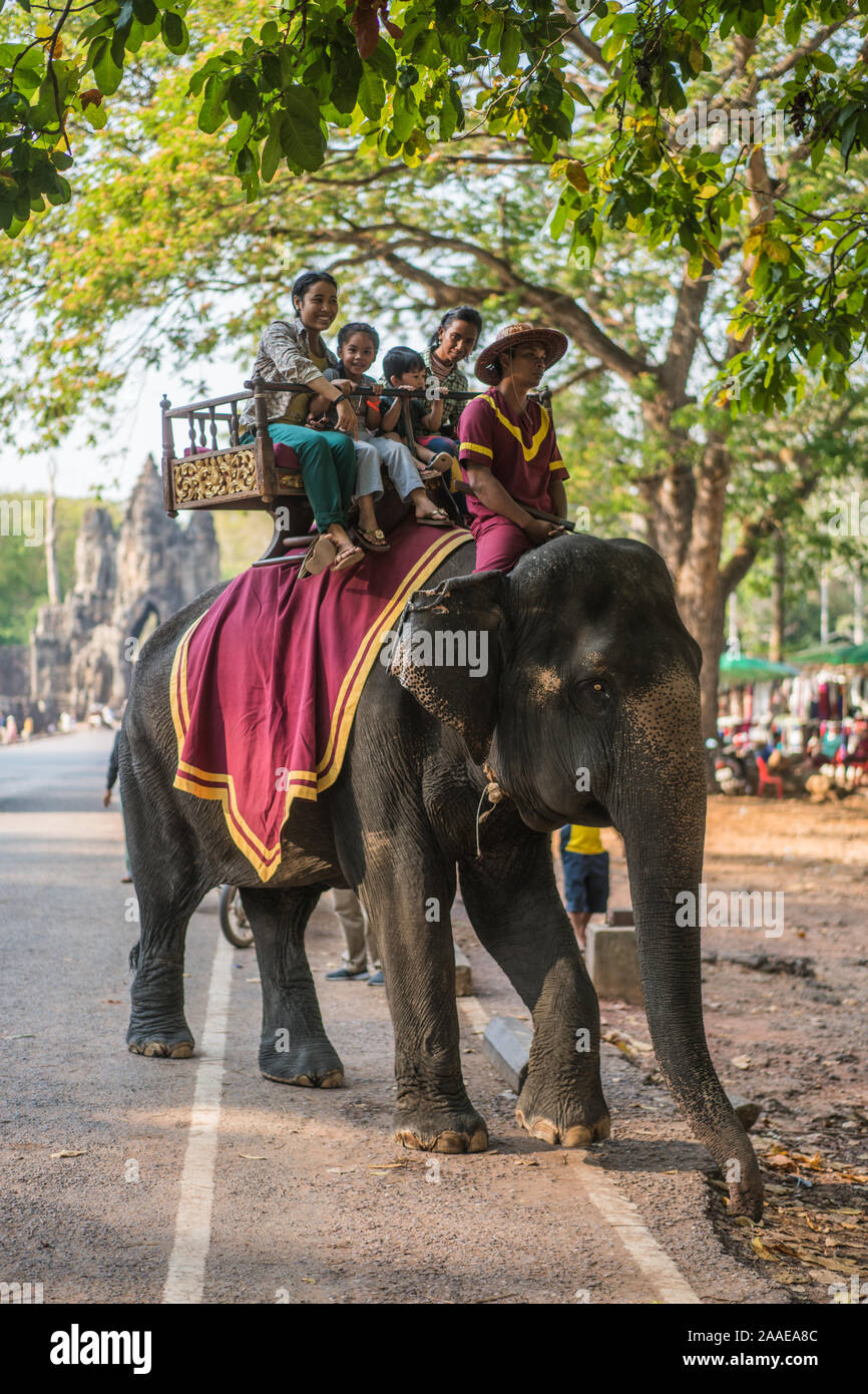 Tourists on the elephant in formt of Tonle Om Gate, South Gate Angkor Thom, Cambodia, Asia. Stock Photo