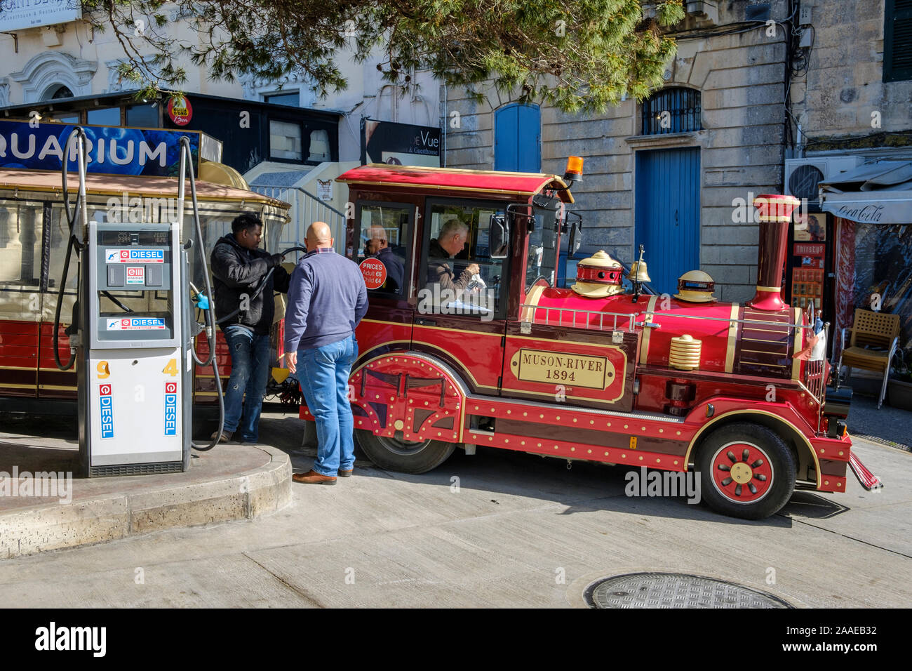 Filling up at the petrol station - the road train which takes tourists around Mdina and Rabat in Malta Stock Photo