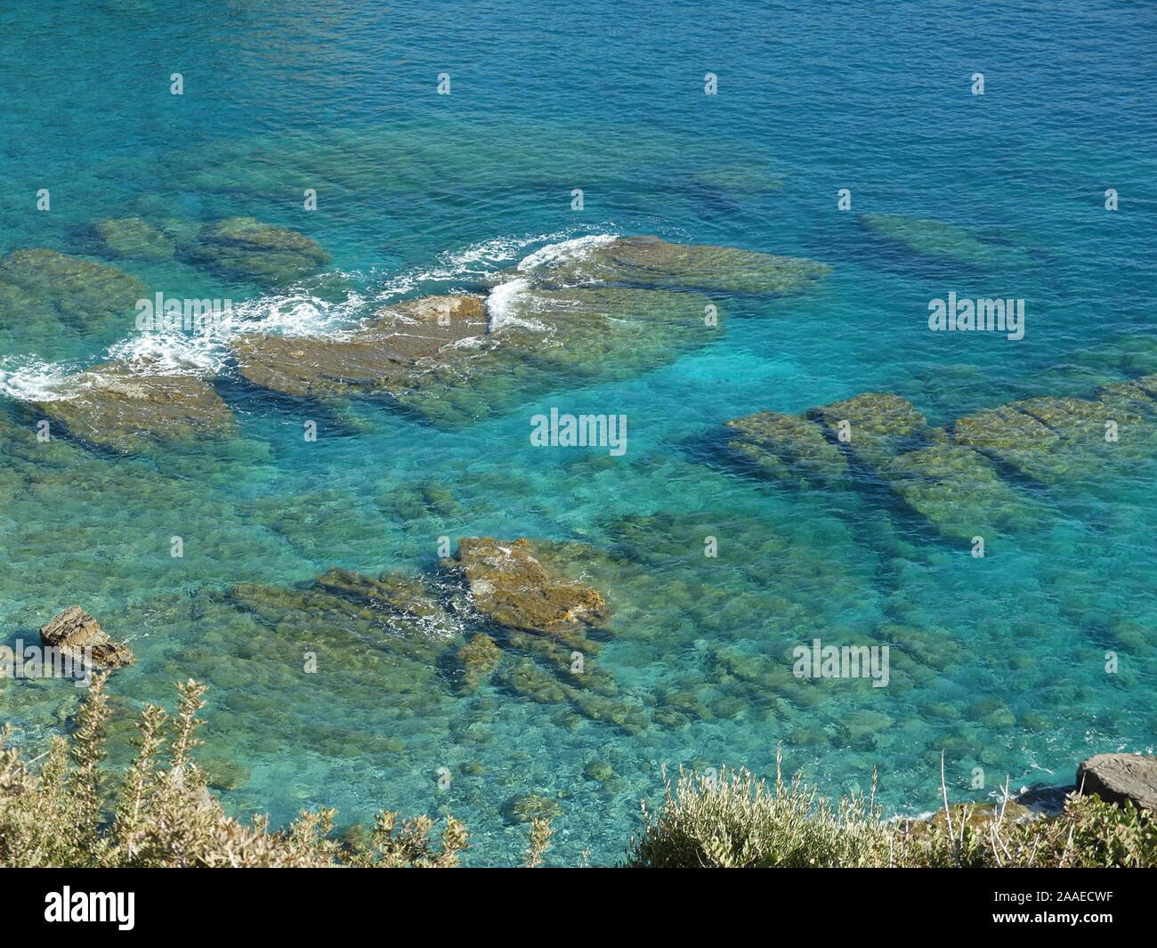 Clear Sea Rocks clear sea water with rocks and foam Stock Photo - Alamy