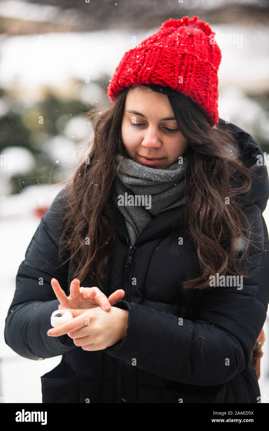 woman using cream at cold winter weather. skin protection Stock Photo